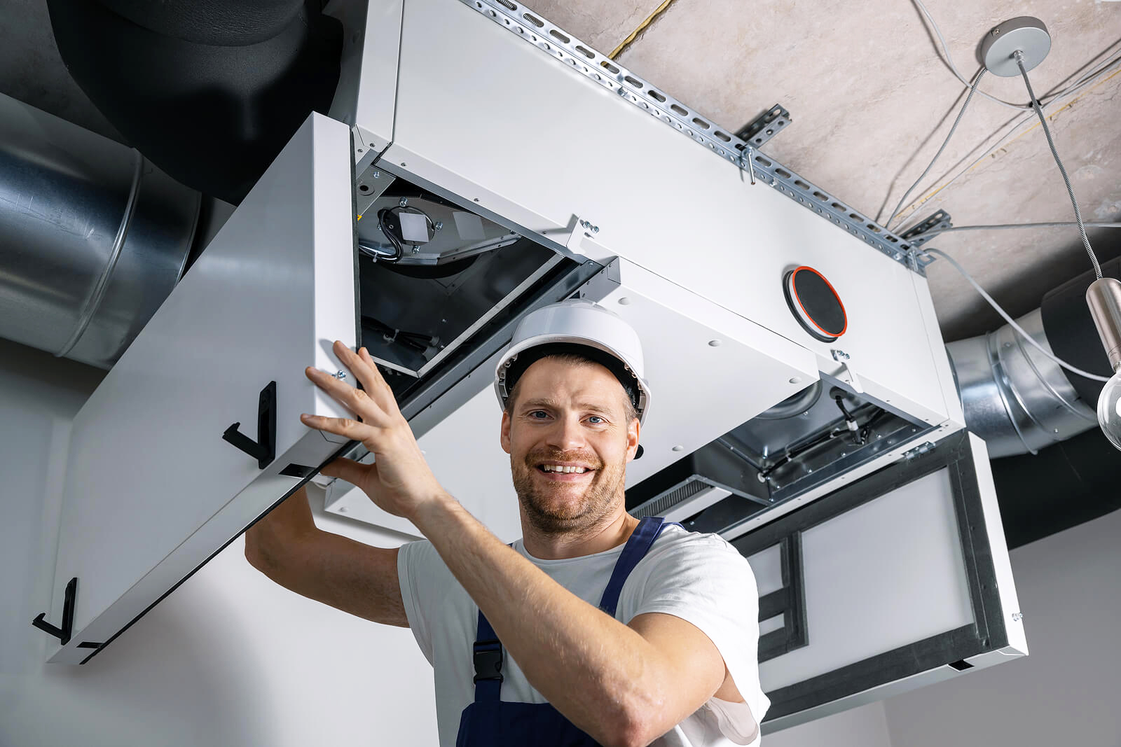 HVAC Technician working on air ducts